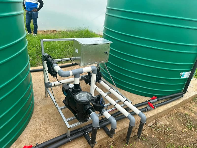 An irrigation pump and filter manifold between two green water tanks