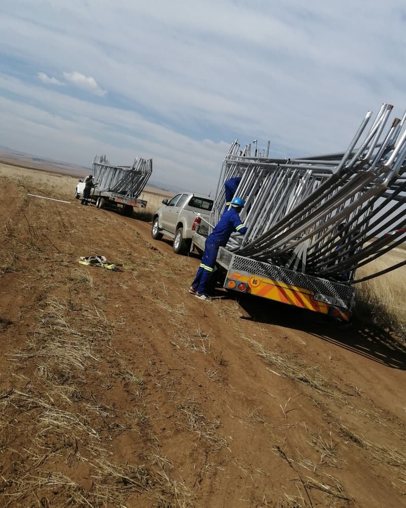 Steel tunnel arches being unloaded from a truck on site
